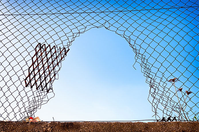 hole at a chainlink fence