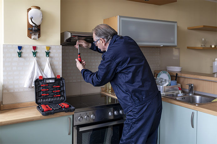 Man installing range hood that isn't vented