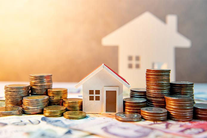 Stacks of coins next to little model houses