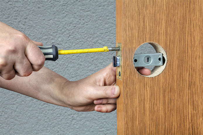 Taking the screws out from the latch plate on the door