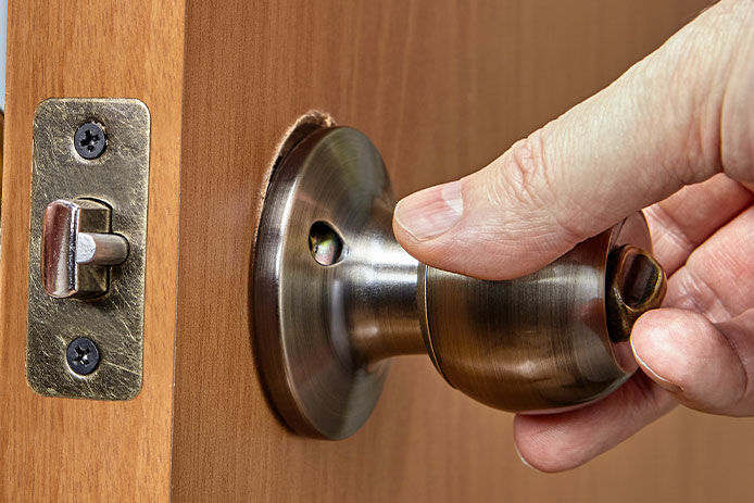 A person turning a door knob