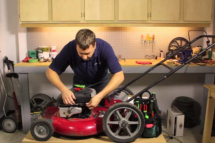 Man servicing his lawn mower