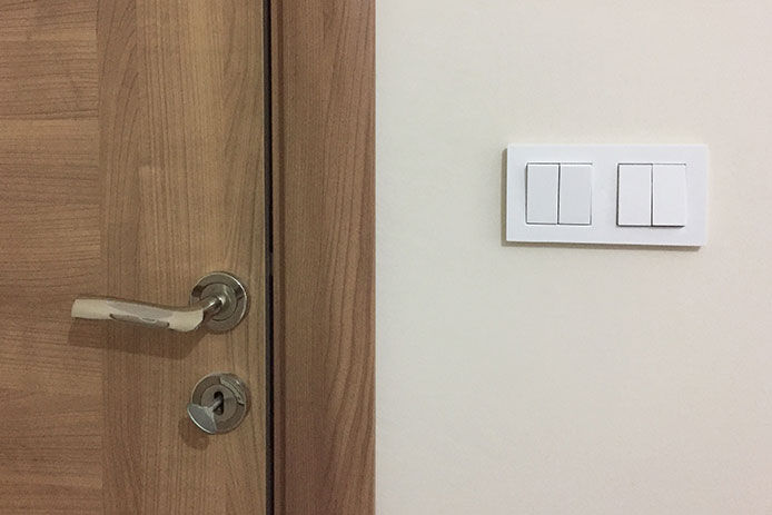 A light switch next to the door