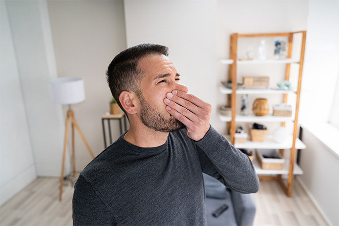 Man holding nose 