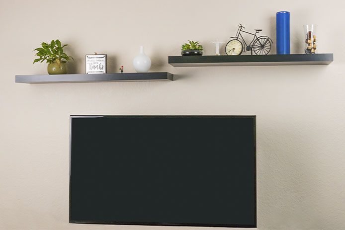 Floating shelves above the TV