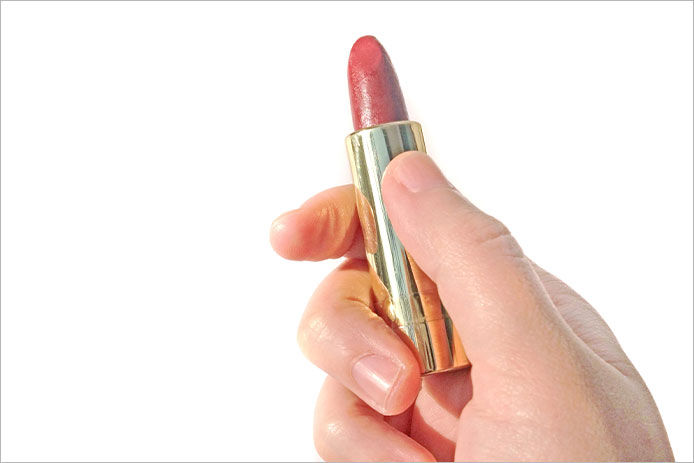 A person holding a lipstick