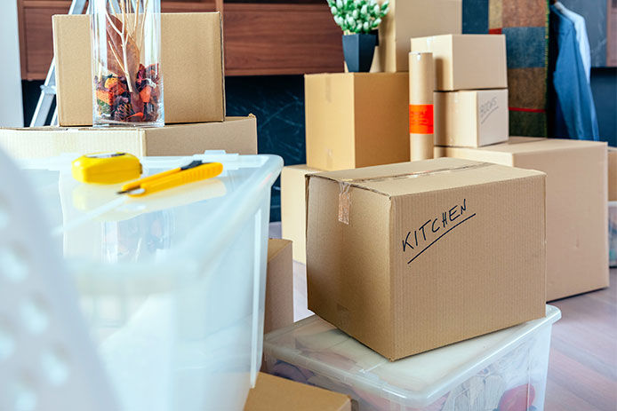 Boxes stacked with one box marked as for kitchen