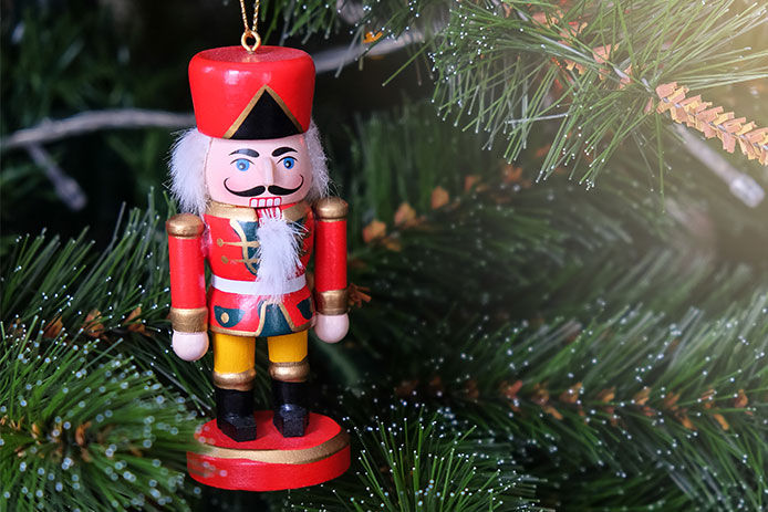 Nutcracker ornament handing on Christmas tree