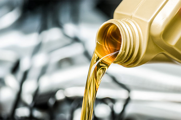 Pour motor oil to car engine. Fresh yellow liquid change with back light. Maintenance or service vehicle concept.