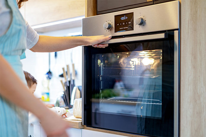 Woman preheating the oven