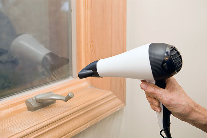 Applying shrink film to a window using a hair dryer