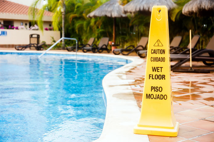 Wet floor warning sign on a swimming pool in Mexico