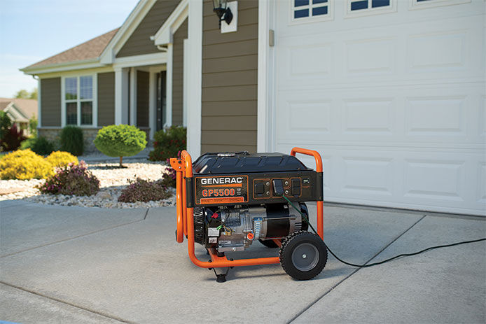 Portable generator sitting in a residential driveway