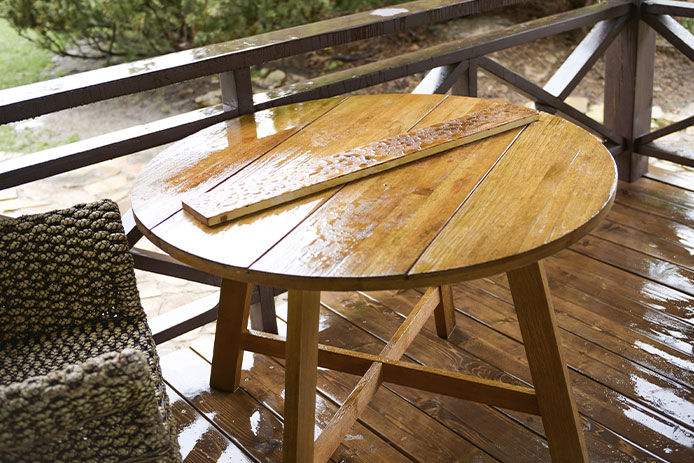 Wooden table out in the rain