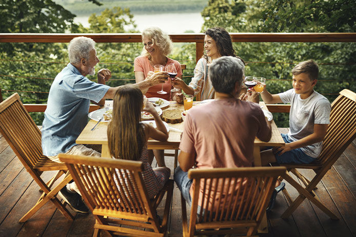 Family sitting at wooden table 