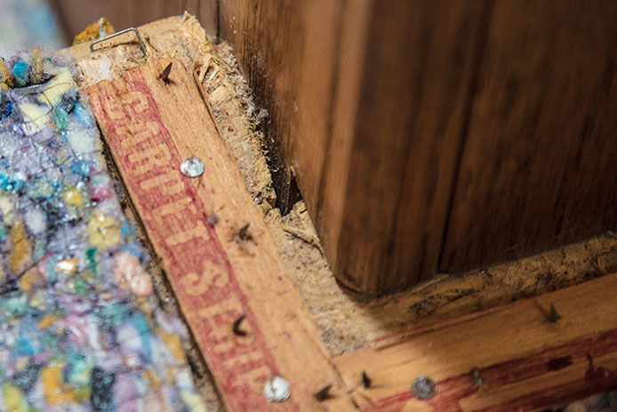 Close-up of tacks and strip from carpeting