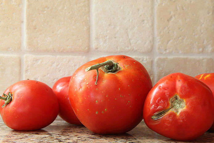 Tomatoes slowly going bad on kitchen countertop