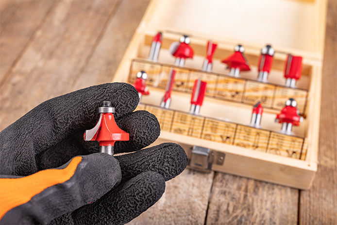A person holding a router bit