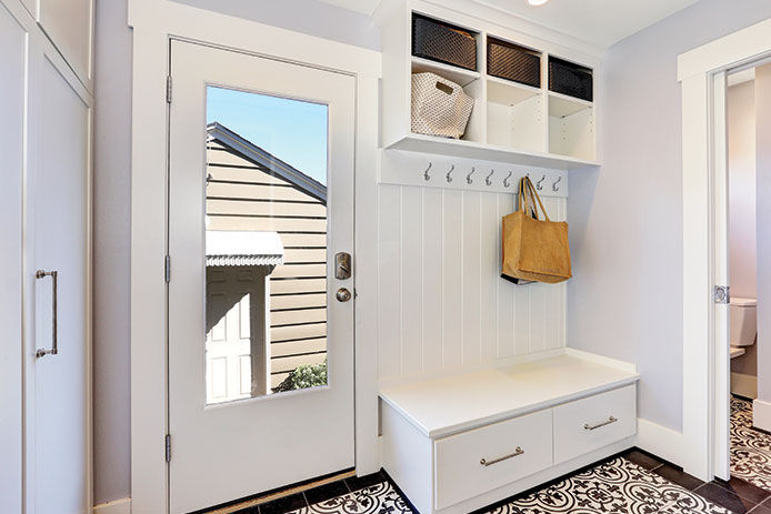 A mudroom featuring hooks for jackets and cubbies for storage