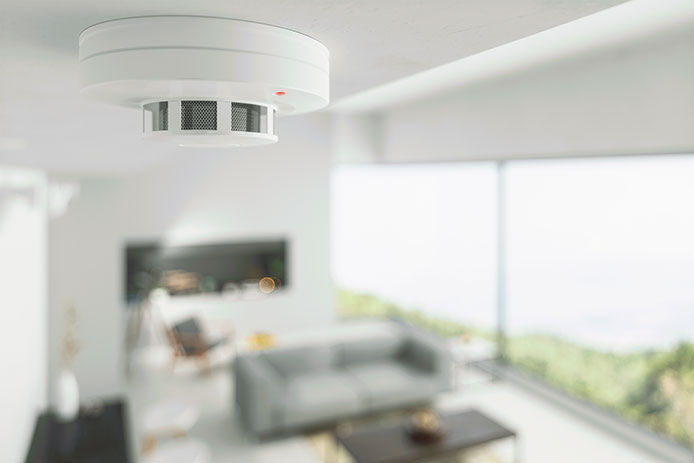 A close-up of a fire alarm in a living room