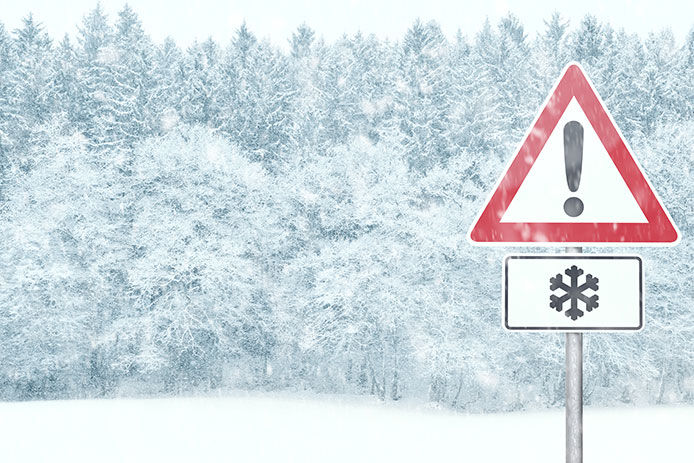 A caution sign with a snowflake