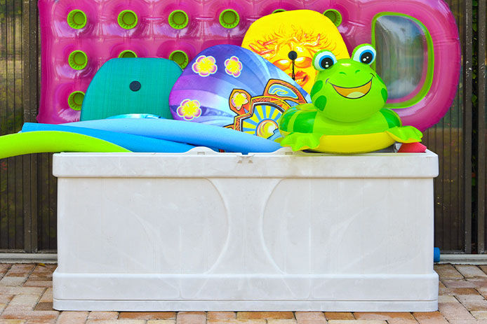 Colorful Inflatable Pool Floats in a storage box on the Swimming Pool Deck