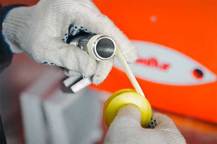 Person putting thread sealing tape around the threads for the shower head