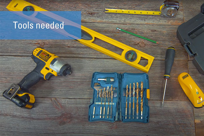 An image of power tools and hand tools needed to install a sliding barn door in your home