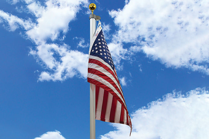 Valley Forge Flags - An American flag waving in the blue sky