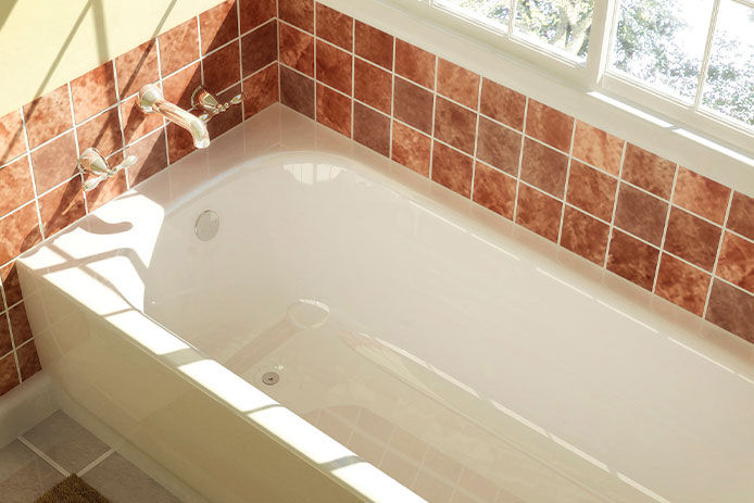 Freshly painted bathtub with pink tile surrounding