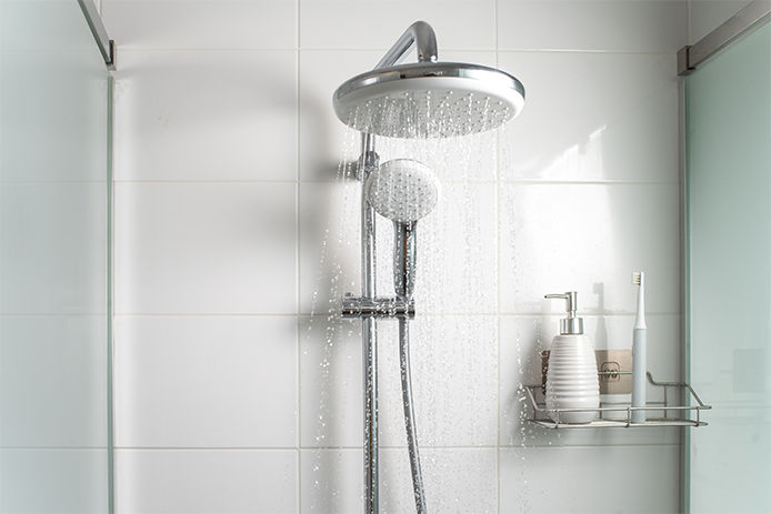 A chrome waterfall shower head