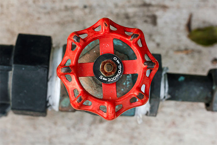 A red handled water shut off valve 