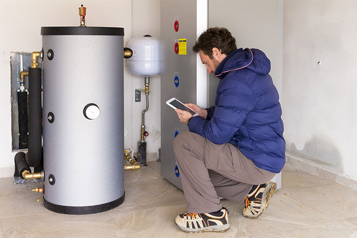 Man inspecting a water heater