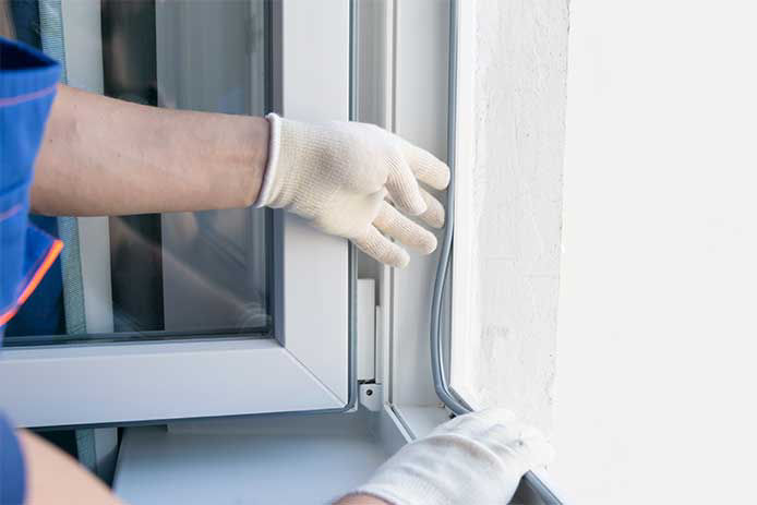 Applying weatherstripping to a window 