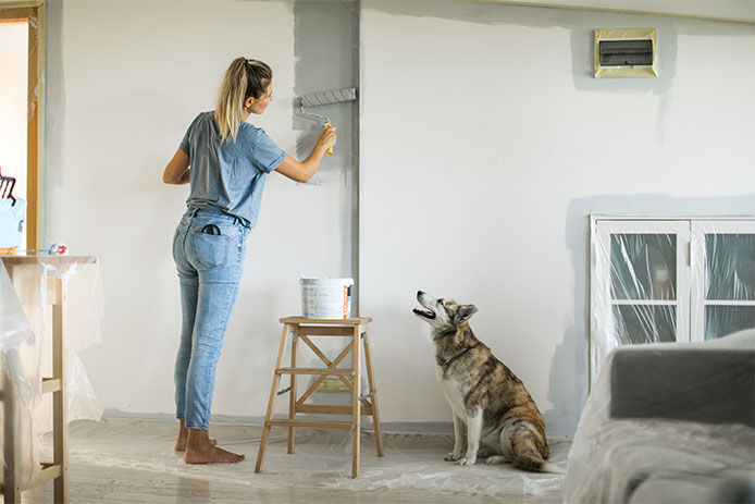 Woman using a paint roller