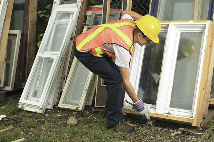 Construction worker going to pick up a used window