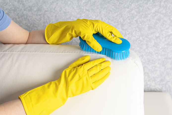 Woman cleaning couch