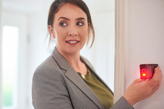 Woman using a laser distance measurer