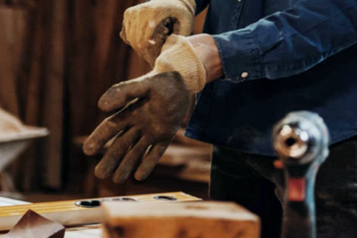 A person putting on work gloves