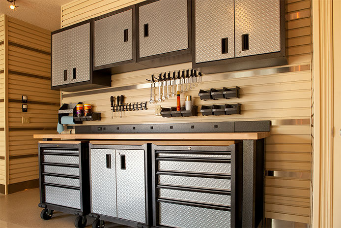 Cabinets and rolling table in garage workspace