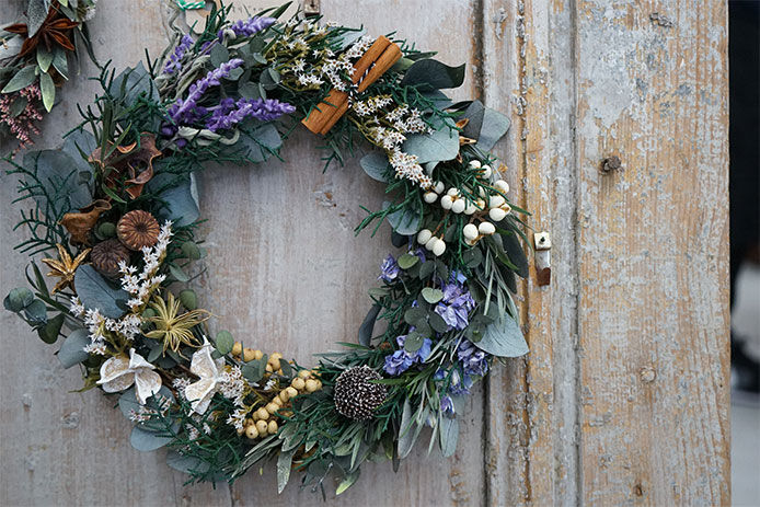 A winter wreath hung on a wooden door