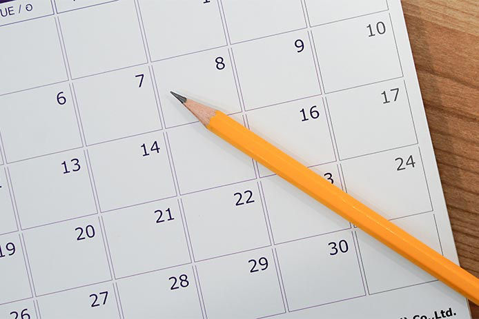 Close up of a calendar and a pencil