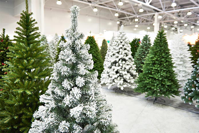 A store display of artifical Christmas trees