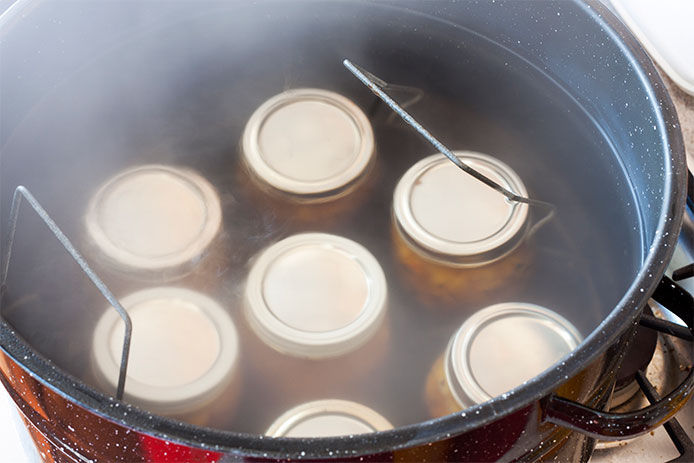 Canning jars in a boiling pot of water