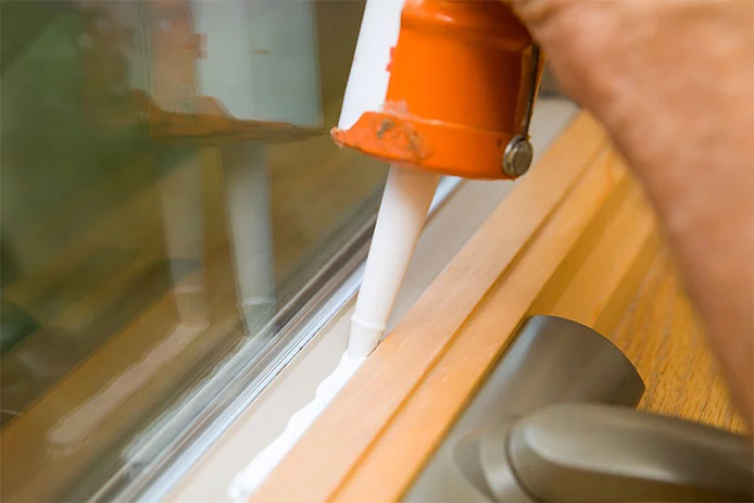 Using caulk to seal a drafty window