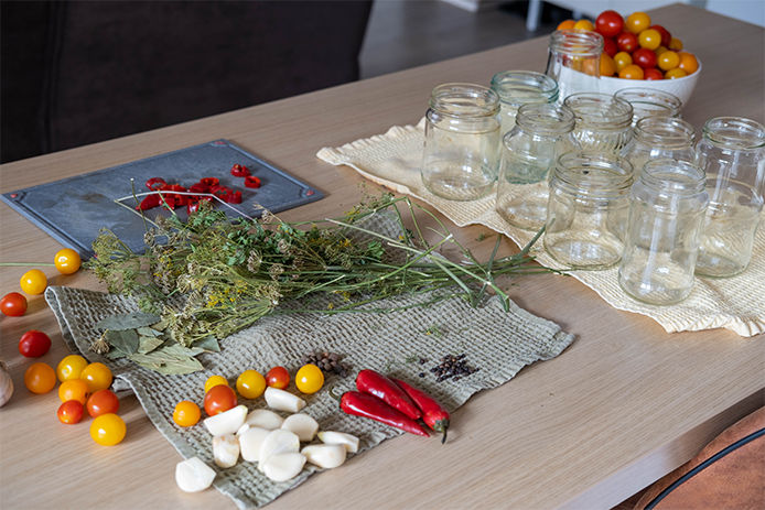 Home canning. Ingredients for pickling tomatoes, garlic, dill, peas, mustard seeds, hot pepper. Pickled tomatoes. Homemade preparations.