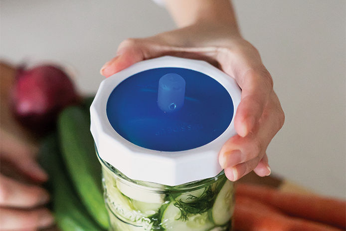 Fermenting a jar of cucumbers using a fermenting lid