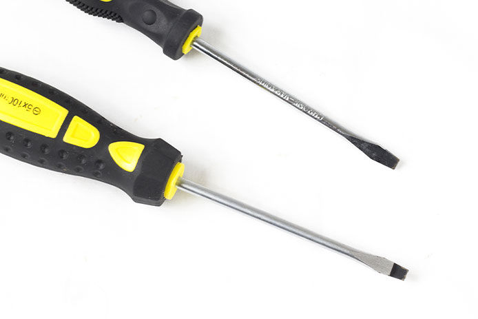 Two flat head screwdrivers against a white background