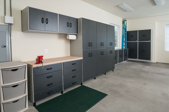 A garage workspace with plenty of cabinet storage