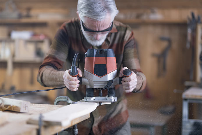 A man steadily holding a router